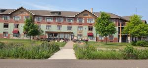 a large building with a pathway in front of it at Canal Park Lodge in Duluth