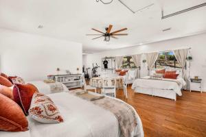 a living room with two beds and a table at Spacious Villa Private Gameroom in Fallbrook +67 photos