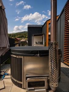 a kitchen with a stove on a balcony at The NEST Villa in Borşa