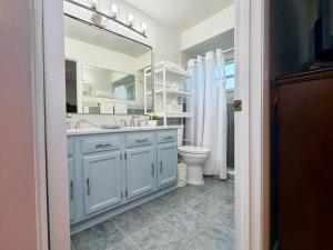 a bathroom with a sink and a toilet and a mirror at Near KSC - Peaceful Spacious Home for 6 - Fully Stocked Kitchen and Coffee Bar in Titusville +14 photos
