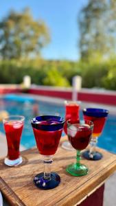 a group of wine glasses sitting on a wooden table at La Finca Roja 3 in Coín
