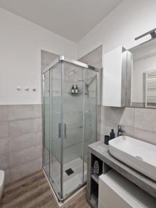 a bathroom with a glass shower and a sink at A 2 min dal Trenino Rosso Monolocale CLESSIDRA1 in Tirano +48 photos