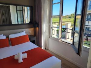 a bedroom with a bed with a cross on it at Adagio Serris Val d'Europe in Serris +71 photos