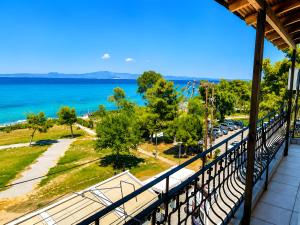 a balcony with a view of the ocean at Plaza Hotel in Hanioti