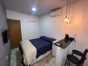 a bedroom with a bed and a table and chairs at Aura Mar Flat in Baía Formosa +10 photos