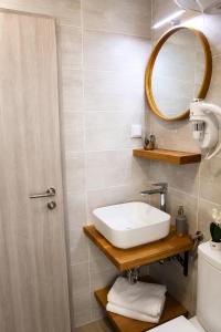 a bathroom with a sink and a mirror at Trogir Square Apartment in Trogir +11 photos