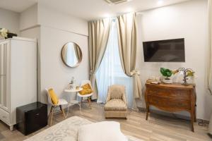 a bedroom with a dresser and a chair and a table at Covo di Levante, in La Spezia
