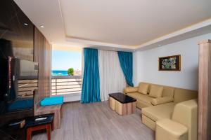 a living room with a couch and a flat screen tv at Aqua Fun Resort in Hurghada