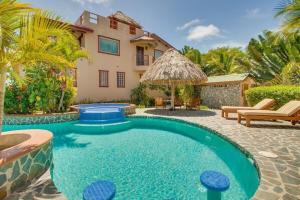 a swimming pool in front of a house at Magnificent Belize Townhouse-Pool-Private Island in Placencia