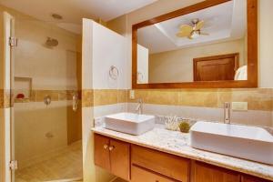 a bathroom with two sinks and a large mirror at Magnificent Belize Townhouse-Pool-Private Island in Placencia
