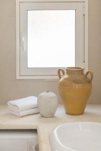 a vase sitting on a counter next to a sink at Ithaca Garden Villa, Kioni in Kiónion