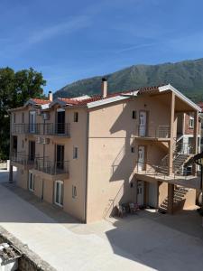 a building with balconies on the side of it at Apartman Đole&Ljuba -Radanovići , Kotor in Ðuranovići