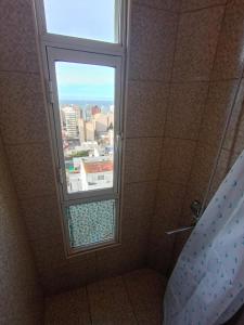 a bathroom with a shower with a window at Monoambiente chico in Miramar