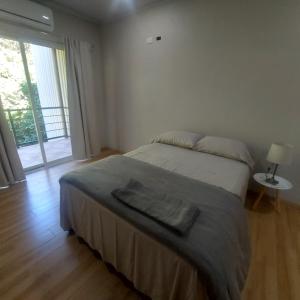 a bedroom with a bed and a large window at Casa Congo Tamarindo in Villarreal