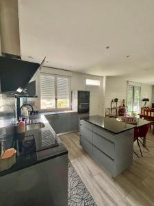 a large kitchen with a counter top and a table at Casascope in Jaunay-Clan
