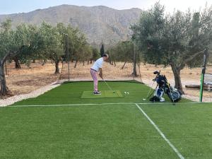 a man is playing golf on a golf course at Villa Tosto in Castelluzzo