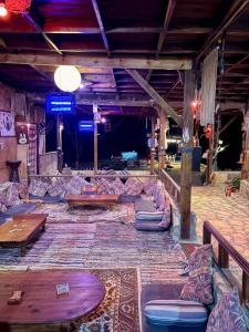a living room with couches and tables in a room at Salah boutique camp in Nuweiba