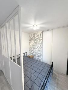 a bedroom with a bed in a room at Large studio Independent sleeping area Swimming pool in Annemasse