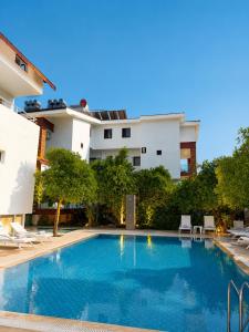 a swimming pool in front of a building at The Selection Butik Otel in Kemer