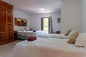 a bedroom with two beds and a dresser at House antigua Guatemala in Antigua Guatemala