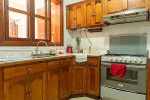 a kitchen with wooden cabinets and a stove top oven at House antigua Guatemala in Antigua Guatemala +53 photos