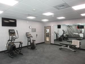 a gym with several treadmills and exercise bikes at Glo Best Western Olive Branch in Olive Branch