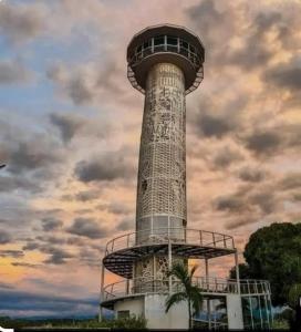 a control tower with a cloudy sky in the background at Hostal Mi Puerto in Puerto Triunfo