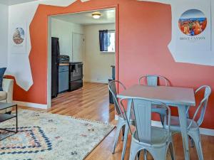 a dining room with a table and chairs and a kitchen at Pet-Friendly Downtown Kanab Basecamp | Hot Tub in Kanab