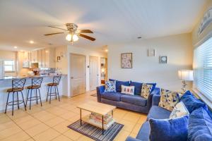 a living room with a blue couch and a table at 'Sea-King Sol' Ocean-View Condo in Port Aransas! in Port Aransas