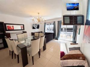 a dining room and living room with a table and chairs at Moderno dpto céntrico CNH in Santiago del Estero