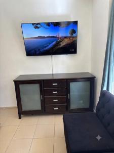 a entertainment center with a flat screen tv on a wall at Moderno dpto céntrico CNH in Santiago del Estero +1 photo
