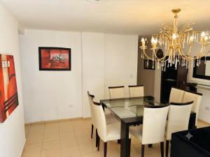 a dining room with a glass table and chairs at Moderno dpto céntrico CNH in Santiago del Estero