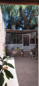 a house with a white fence and a patio at Casa M in Tilcara