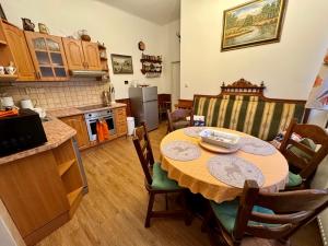 a kitchen with a table and chairs in a room at Chalupa U Potoka in Josefŭv Dŭl +43 photos