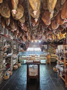 a bakery with a bunch of bread hanging from the ceiling at B&B Cortijo Nunca Pense in Órgiva