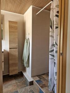 a bathroom with a walk in shower and a tile floor at B&B Cortijo Nunca Pense in Órgiva +51 photos