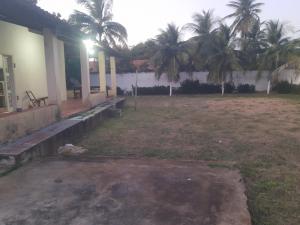 a house with palm trees in the yard at Casa Marina Morro Branco in Beberibe