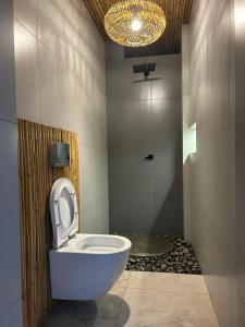 a bathroom with a white toilet and a shower at Kapiro Ecolodge Satipo in Satipo