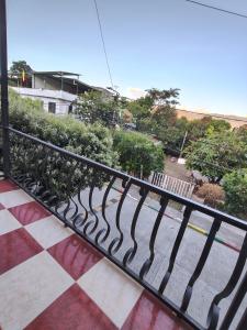 a black metal railing on a balcony with trees at Villa Tania in Melgar