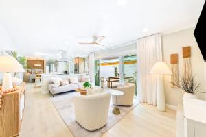 a living room with white furniture and a kitchen at Designer Del Mar Escape Beach Dining & Shops in San Diego