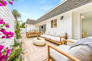 a patio with a couch and a table at Designer Del Mar Escape Beach Dining & Shops in San Diego