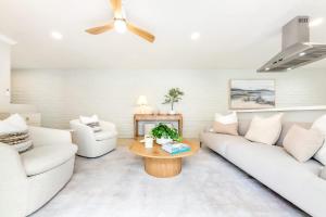 a living room with two white couches and a coffee table at Designer Del Mar Escape Beach Dining & Shops in San Diego