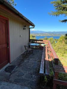 a patio with a table and a bench next to a building at Cabañas Rayen Lemu in Panguipulli
