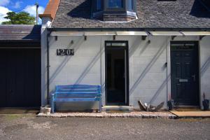 a blue bench sitting outside of a house at Lily Bank Room in Stonehaven +49 photos