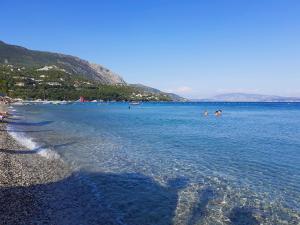 a group of people swimming in a large body of water at Villa Valia Seaside in Ipsos