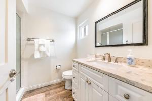 a white bathroom with a sink and a mirror at Del Mar Studio - Walk to Beach in San Diego