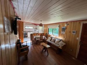 a living room with a couch and a table at Cabañas Rayen Lemu in Panguipulli