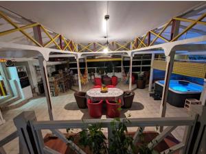 a patio with a table and chairs and a pool at Villa Ti Balcon avec jacuzzi in Fort-de-France