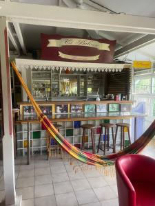 a hammock in a restaurant with a bar at Villa Ti Balcon avec jacuzzi in Fort-de-France