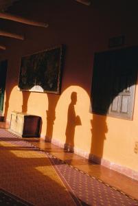 a shadow of a man standing next to a wall at Monasterio, A Belmond Hotel, Cusco in Cusco